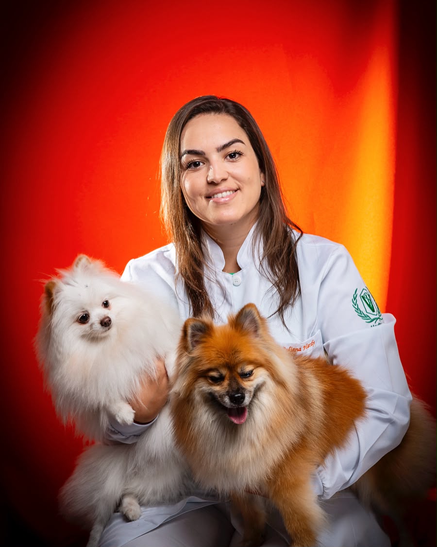 Dra. Juliana Hardy com dois cães durante atendimento veterinário